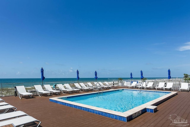 view of swimming pool featuring a water view