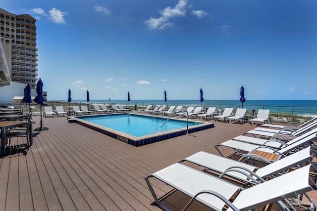 view of swimming pool with a water view