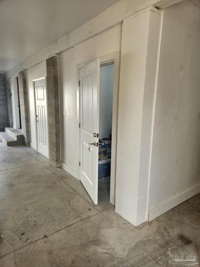 corridor featuring concrete flooring