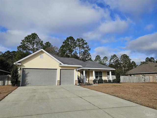 ranch-style house featuring a garage and covered porch