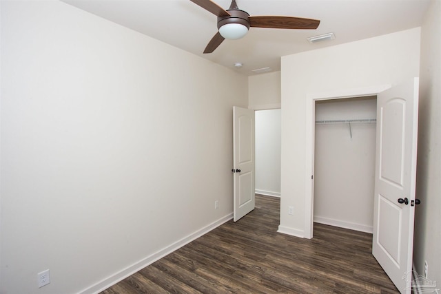 unfurnished bedroom with a closet, ceiling fan, and dark hardwood / wood-style flooring