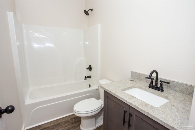 full bathroom with hardwood / wood-style floors, vanity, shower / bathtub combination, and toilet