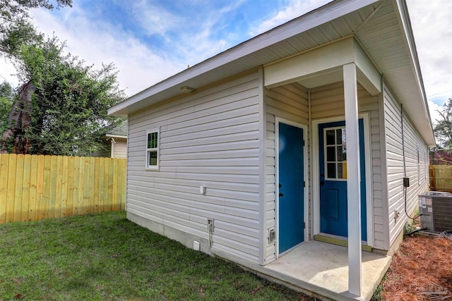 view of home's exterior featuring a lawn, an outbuilding, and cooling unit