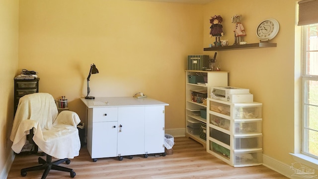 home office with plenty of natural light and light wood-type flooring