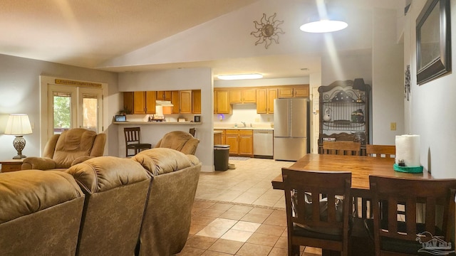 living room featuring sink, high vaulted ceiling, and light tile patterned flooring