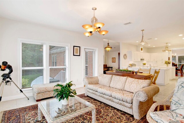 tiled living room with a chandelier