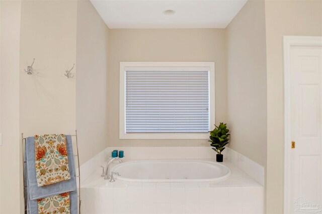 bathroom featuring tiled tub