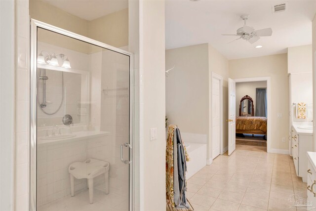 bathroom featuring ceiling fan, vanity, a shower with shower door, and tile patterned flooring