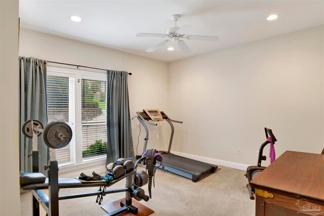 exercise room with ceiling fan and light colored carpet