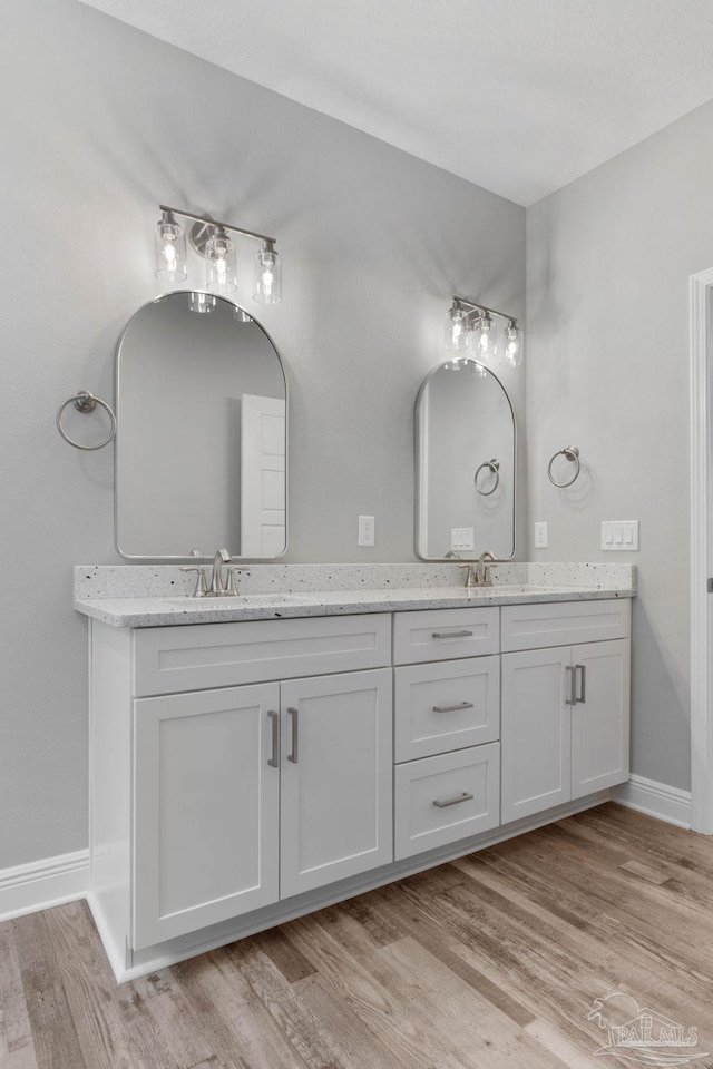 bathroom with vanity and hardwood / wood-style floors