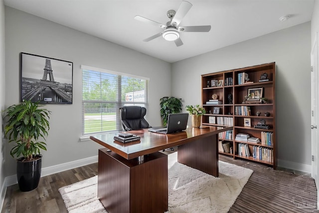 home office featuring dark hardwood / wood-style floors and ceiling fan