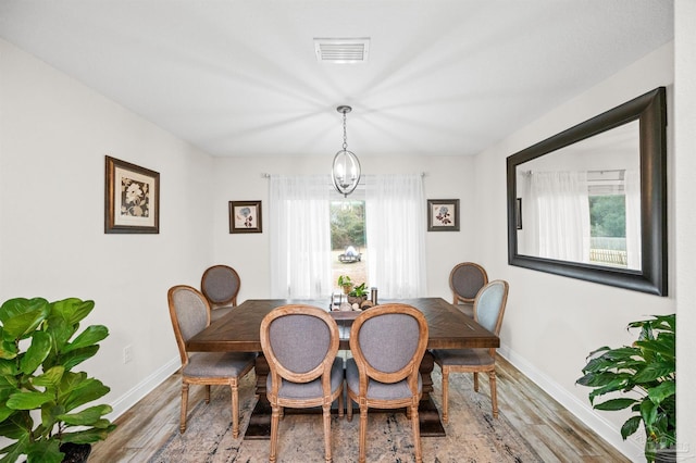 dining room featuring a notable chandelier and wood-type flooring