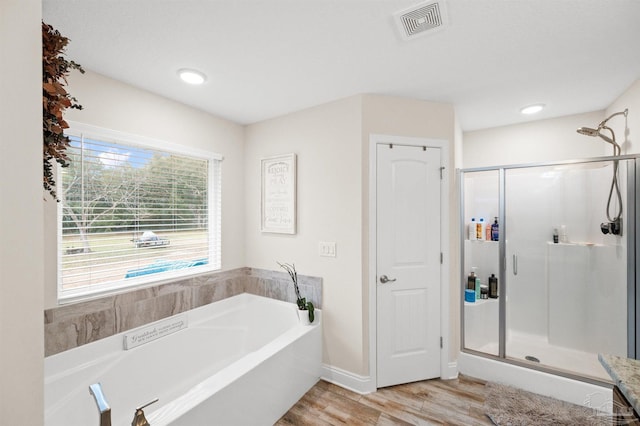 bathroom with separate shower and tub and hardwood / wood-style floors