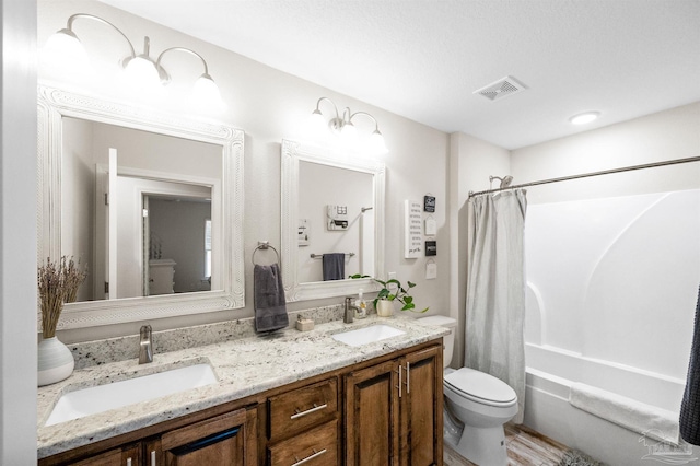 full bathroom featuring vanity, shower / tub combo, and toilet