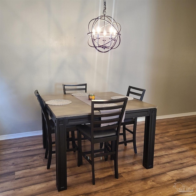 dining space with an inviting chandelier and dark hardwood / wood-style flooring