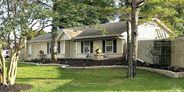 1405 College Pkwy, Gulf Breeze, FL 32563 - view of front of property with roof with shingles, fence, a front yard, and a garage