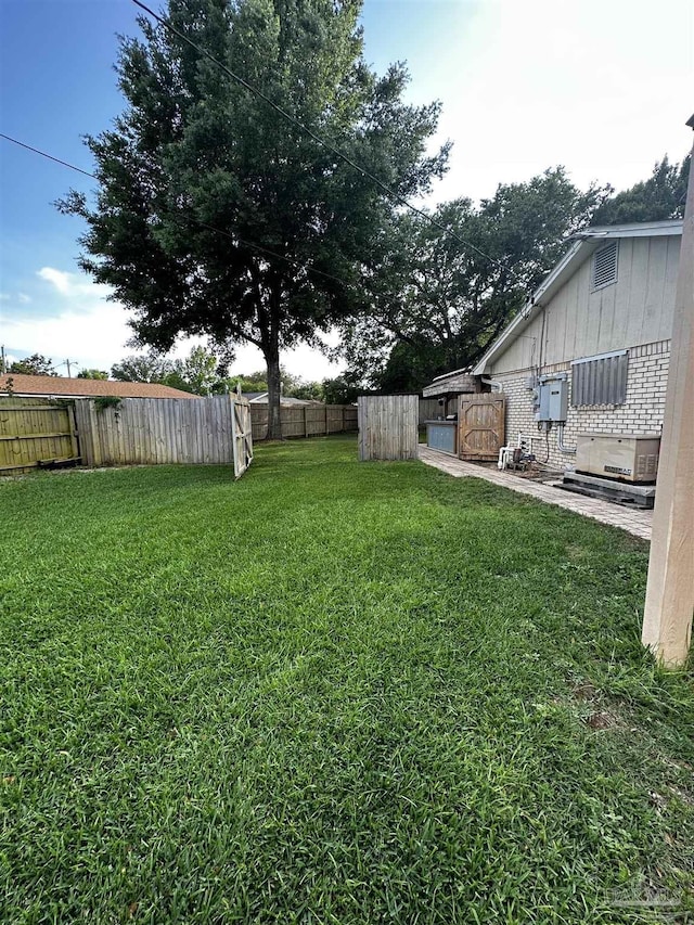1405 College Pkwy, Gulf Breeze, FL 32563 - view of yard featuring central AC and fence