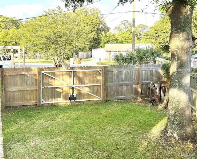 1405 College Pkwy, Gulf Breeze, FL 32563 - view of yard with a fenced backyard and a gate
