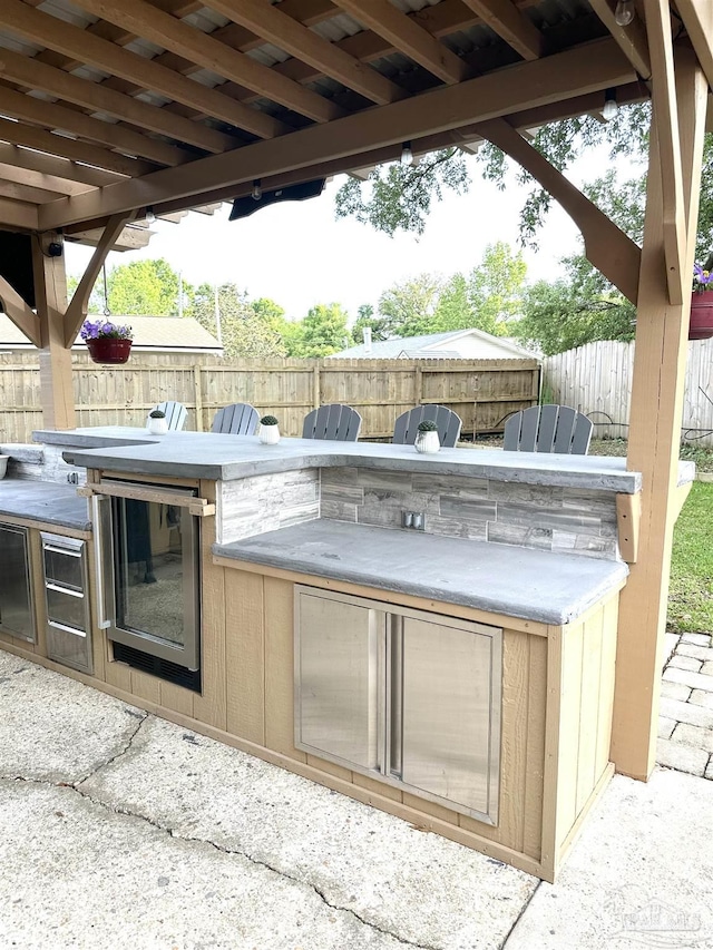 1405 College Pkwy, Gulf Breeze, FL 32563 - view of patio / terrace with exterior kitchen and a fenced backyard