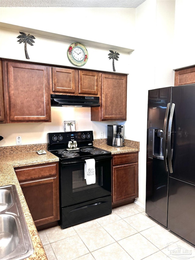 1405 College Pkwy, Gulf Breeze, FL 32563 - kitchen featuring a sink, light tile patterned floors, light stone counters, black appliances, and under cabinet range hood