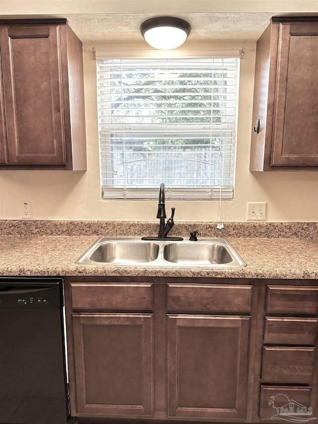 1405 College Pkwy, Gulf Breeze, FL 32563 - kitchen featuring light countertops, a textured ceiling, a sink, and dishwasher