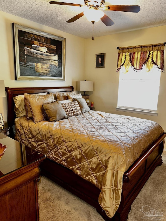 1405 College Pkwy, Gulf Breeze, FL 32563 - bedroom featuring a textured ceiling, carpet, and a ceiling fan
