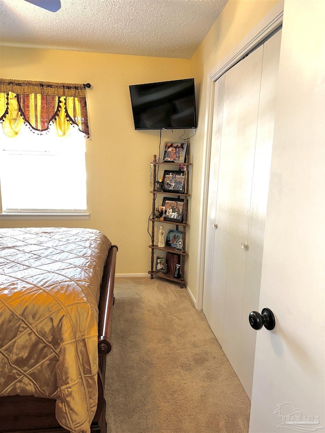 1405 College Pkwy, Gulf Breeze, FL 32563 - carpeted bedroom with baseboards, a closet, and a textured ceiling