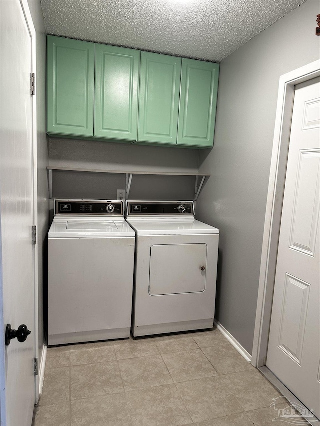 1405 College Pkwy, Gulf Breeze, FL 32563 - washroom with a textured ceiling, washing machine and dryer, cabinet space, light tile patterned floors, and baseboards