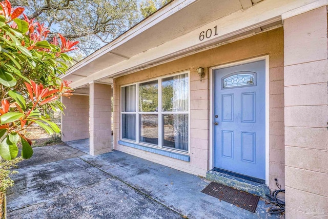 property entrance with concrete block siding