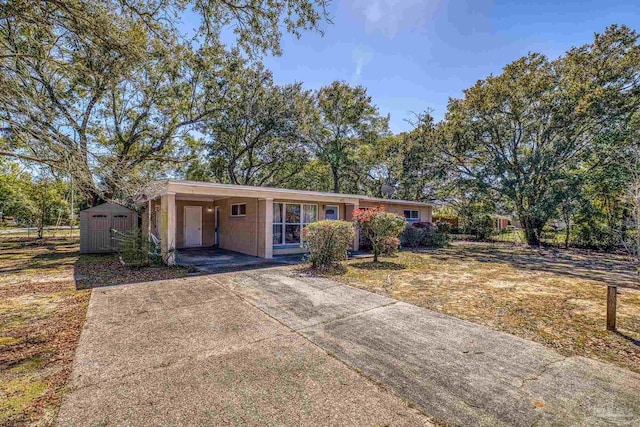 ranch-style home featuring an attached carport and concrete driveway