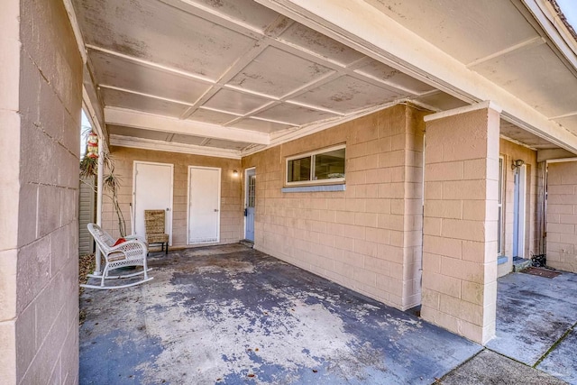 view of exterior entry featuring concrete block siding