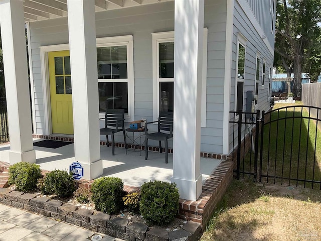 view of patio with covered porch and fence