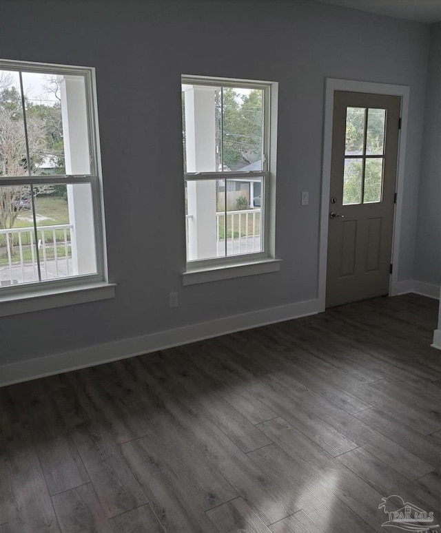 interior space featuring baseboards and wood finished floors