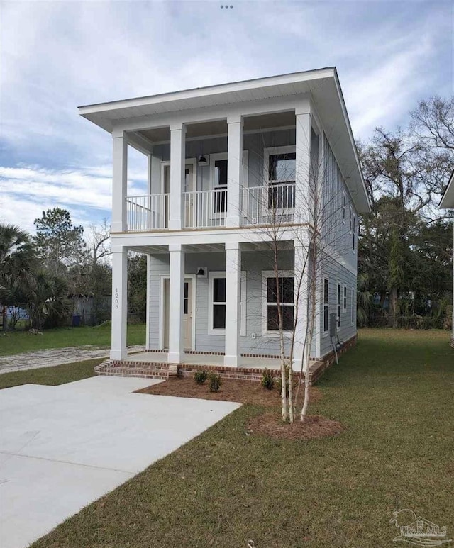 greek revival house with covered porch, a front lawn, and a balcony