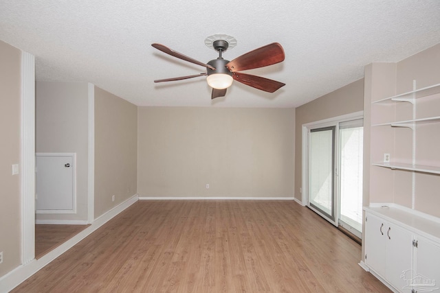 unfurnished room with light hardwood / wood-style floors, a textured ceiling, and ceiling fan