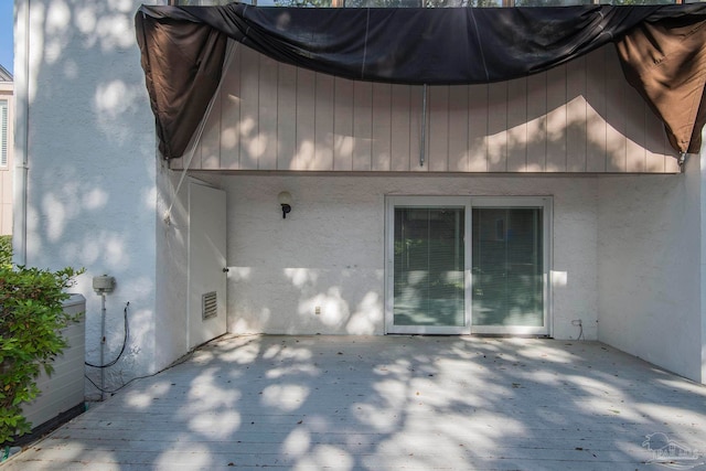 rear view of property featuring a wooden deck