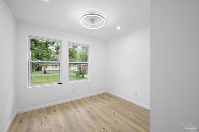 spare room with a healthy amount of sunlight and light hardwood / wood-style flooring