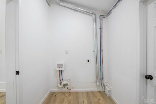 clothes washing area featuring washer hookup, light hardwood / wood-style flooring, and hookup for an electric dryer