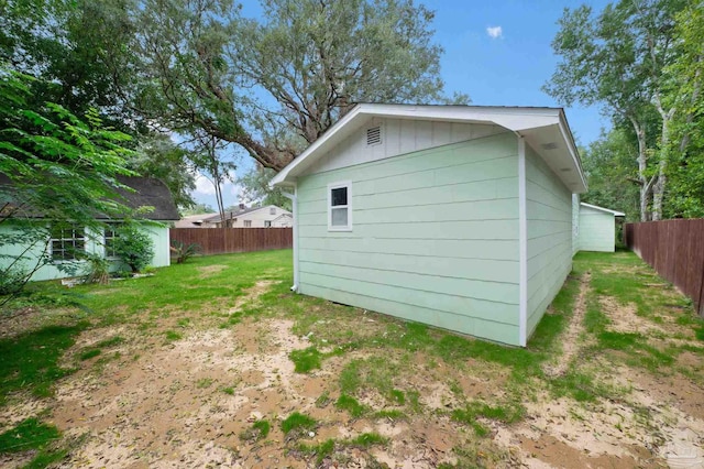 view of outbuilding with a lawn