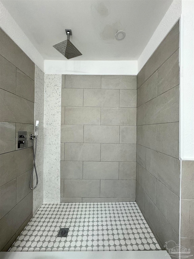 bathroom with a tile shower