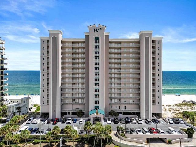 view of property featuring a beach view and a water view