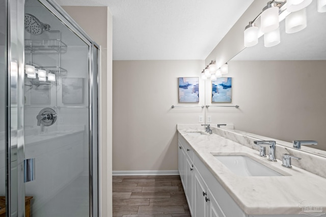 bathroom with an enclosed shower and vanity