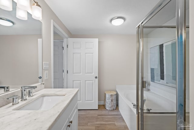 bathroom featuring shower with separate bathtub and vanity