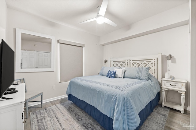 bedroom with ceiling fan and dark hardwood / wood-style floors