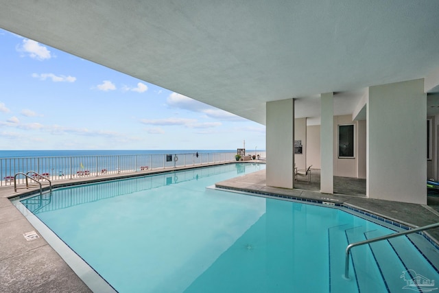 view of pool featuring a water view