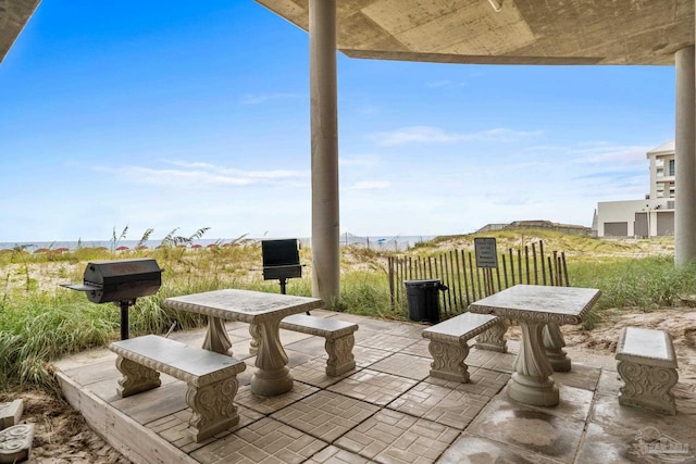 view of patio with a water view