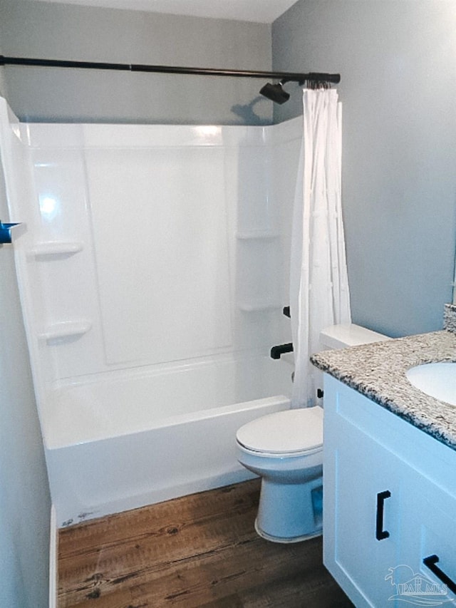 full bathroom with vanity, wood-type flooring, toilet, and shower / bathtub combination with curtain