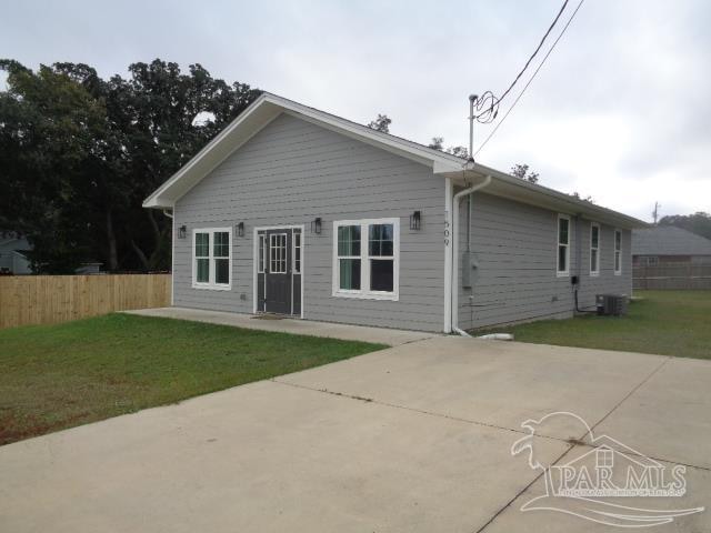 rear view of property featuring a patio area, a lawn, and cooling unit