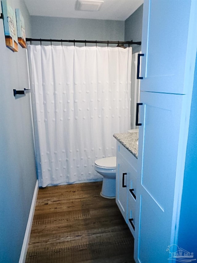 bathroom featuring vanity, toilet, wood-type flooring, and a shower with shower curtain