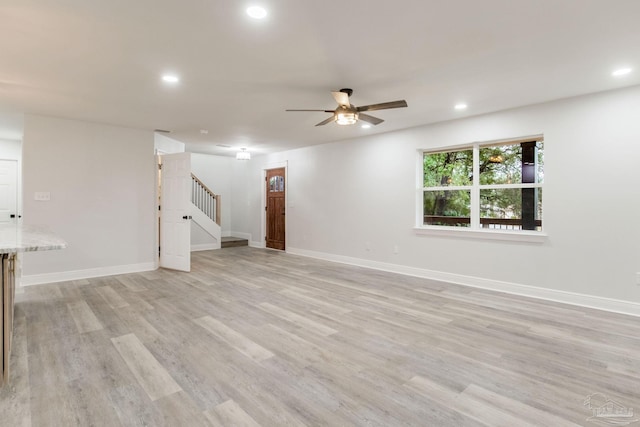 interior space with ceiling fan and light hardwood / wood-style floors